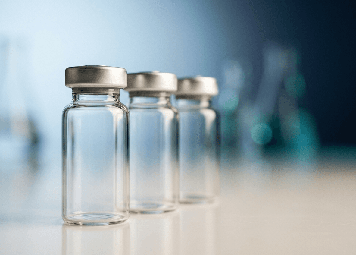 Pharmaceutical-grade glass vials on a softly lit surface